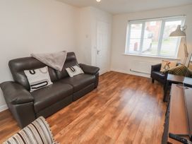 A living room with a sofa and armchair at 26 Field Court