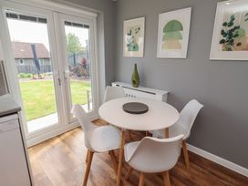 A dining room with a round table and chairs at 26 Field Court