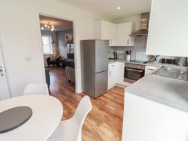 A kitchen with appliances and a dining area at 26 Field Court