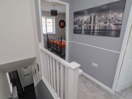 A hallway showing staircase and a bedroom at 26 Field Court