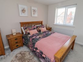 A bedroom with a bed and bedside tables at 26 Field Court