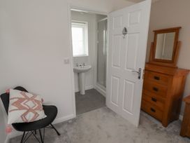 A bathroom with a washbasin and shower at 26 Field Court