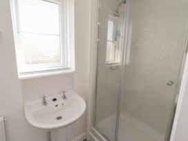 A bathroom with a sink and shower at 26 Field Court