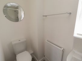 A bathroom with a toilet and a mirror at 26 Field Court
