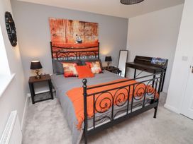 A bedroom with a bed and desk at 26 Field Court 