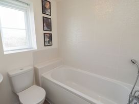 A bathroom with a bathtub and toilet at 26 Field Court