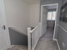 A staircase and hallway leading to a room at 26 Field Court 