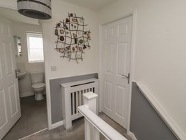 A hallway with a staircase and a toilet at 26 Field Court 