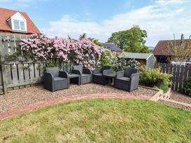 A garden area with chairs and flowers at 26 Field Court