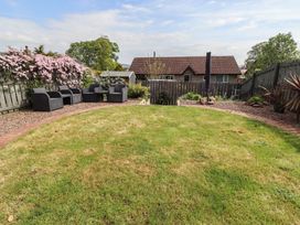 A garden with seating area and plants at 26 Field Court