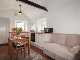 A kitchen with a table and chairs at Primrose Cottage Redruth
