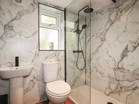 A bathroom with a sink, toilet, and shower at Primrose Cottage, Redruth