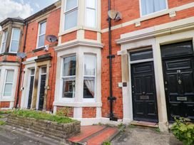 A front exterior view of a building with brick walls and doors at 17 Fairfield Road