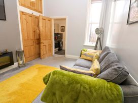 A living room with a sofa and a door at 17 Fairfield Road