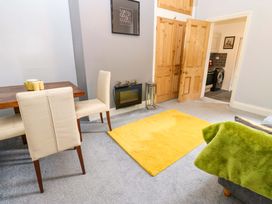 A living room with a dining table and chairs at 17 Fairfield Road