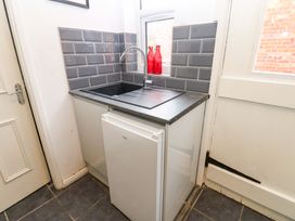 A utility room with sink and refrigerator at 17 Fairfield Road