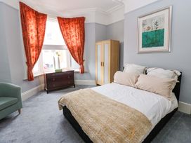 A bedroom with a bed and curtains at 17 Fairfield Road
