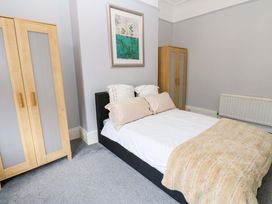 A bedroom with a bed and two wardrobes at 17 Fairfield Road