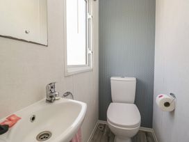 A bathroom with a sink and toilet at Standard Caravan at Three Lochs Holiday Park, Newton Stewart