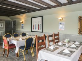 A dining room with a table set for meals at Standard Caravan at Three Lochs Holiday Park Newton Stewart