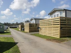 A view of caravans and a road at Lochwood Platinum Superior at Three Lochs Holiday Park in Newton Stewart