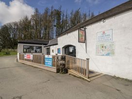 An outdoor view of a building with signs at Lochwood Platinum Superior at Three Lochs Holiday Park, Newton Stewart