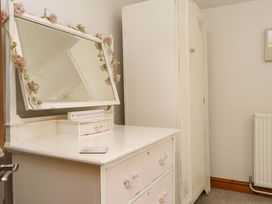 A dressing table and wardrobe in a bedroom at 2 Bryn Eglwys Prenteg