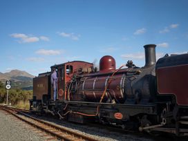 A steam locomotive at a railway station at 2 Bryn Eglwys Prenteg near Porthmadog