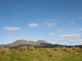 Mountains in a field under a cloudy sky at 2 Bryn Eglwys Prenteg near Porthmadog