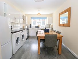 A kitchen with a dining table and appliances at The Mill House Gardens