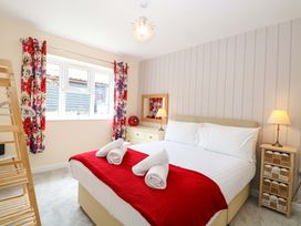 A bedroom with a bed and a dressing table at The Mill House Gardens