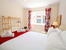 A bedroom with a bed and towels at The Mill House Gardens in 