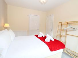 A bedroom with a bed and towels on top at The Mill House Gardens