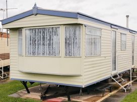 A caravan with windows and a door at Number 186 Owens caravan park Abergele