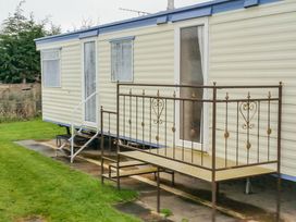 A caravan with steps and railing at Number 186 Owens caravan park Abergele