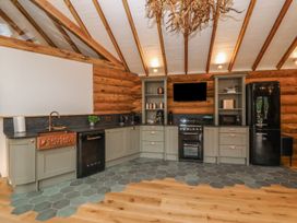 A kitchen with cabinets and appliances at Copper Suite in Chulmleigh