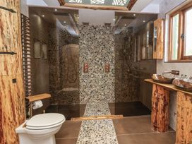 A bathroom with a toilet and shower area at Copper Suite in Chulmleigh