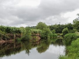 A river surrounded by vegetation at Copper Suite, Chulmleigh
