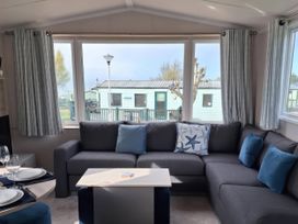 A living room with a sofa and coffee table at St Andrews Holiday Park - Taigh na Mara in St Andrews