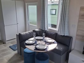 A dining area with a table and chairs at St Andrews Holiday Park - Taigh na Mara, St Andrews