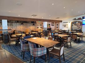 A dining room with tables and chairs at St Andrews Holiday Park - Taigh na Mara, St Andrews