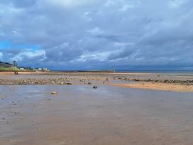 A beach with people walking at St Andrews Holiday Park - Taigh na Mara, St Andrews