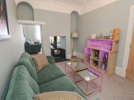 A living room with a sofa and bar unit at 5 Station Avenue