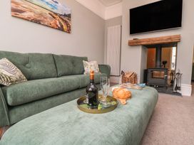 A living room with a sofa and a fireplace at 5 Station Avenue