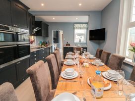 A kitchen with a dining table set for meals at 5 Station Avenue