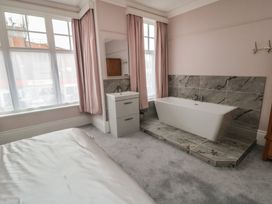 A bathroom with a bathtub and sink at 5 Station Avenue