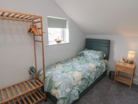 A bedroom with a single bed and a clothes rack at 5 Station Avenue