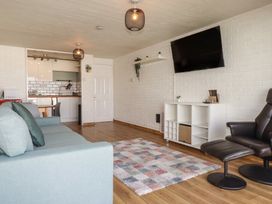 A living room with a sofa and television at A5 Bay Apt.