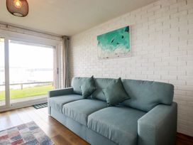 A living room with a sofa and window view at A5 Bay Apt.