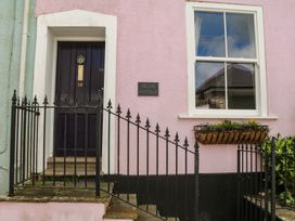 A door and window with a flower box at Tiller Cottage in Dartmouth